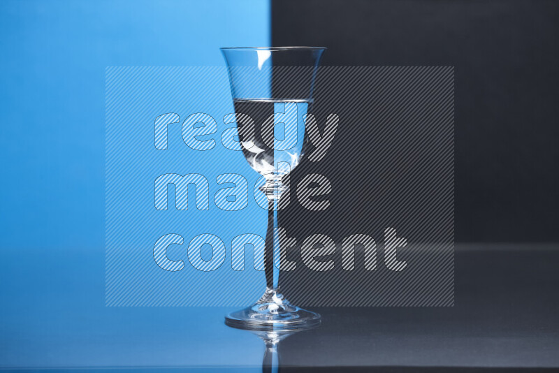 The image features a clear glassware filled with water, set against blue and black background