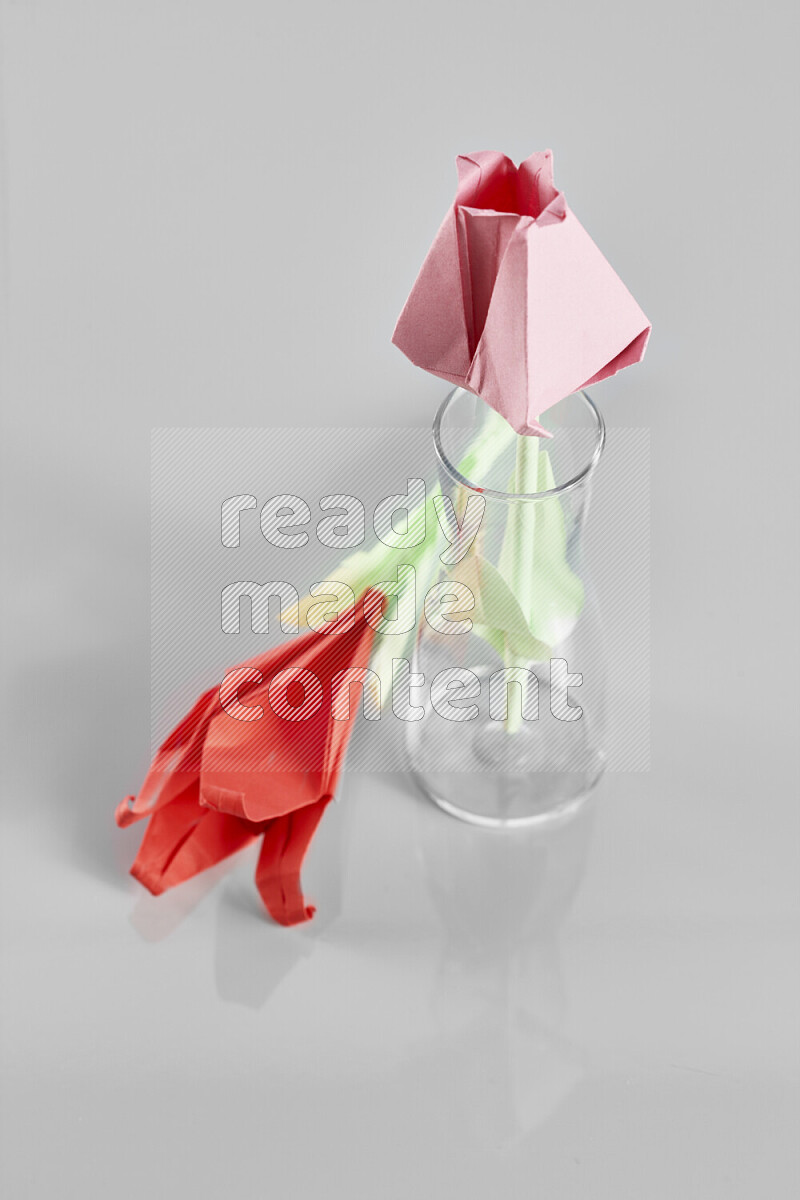 Origami flower on grey background