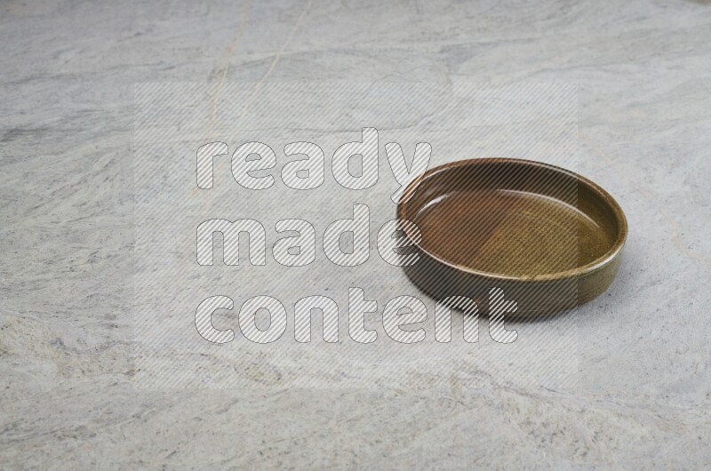 A multicolored pottery oven plate on grey marble background