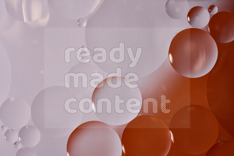 Close-ups of abstract oil bubbles on water surface in shades of white and orange