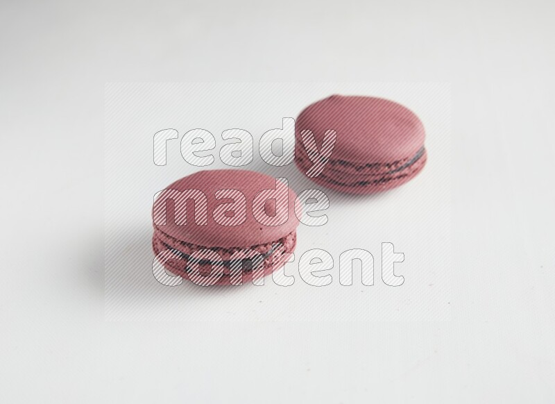 45º Shot of two Red Cherry macarons on white background