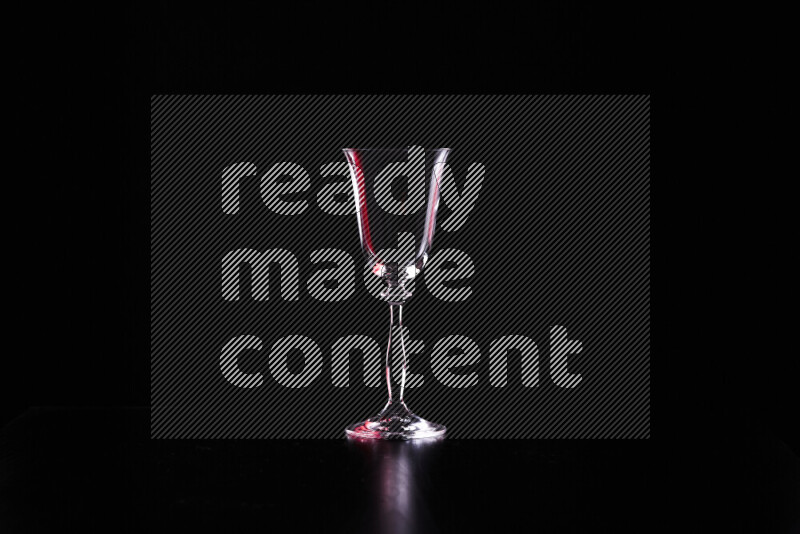 Glassware with rim light in red and white against black background