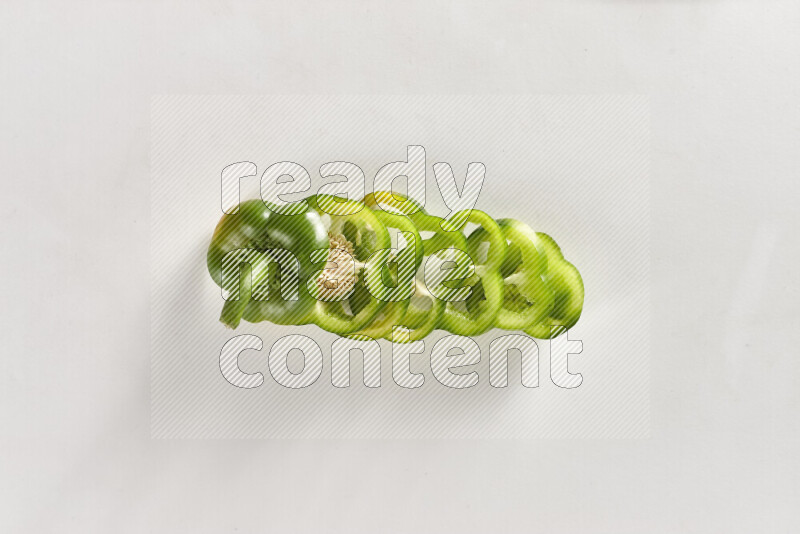 Green bell pepper slices on white background