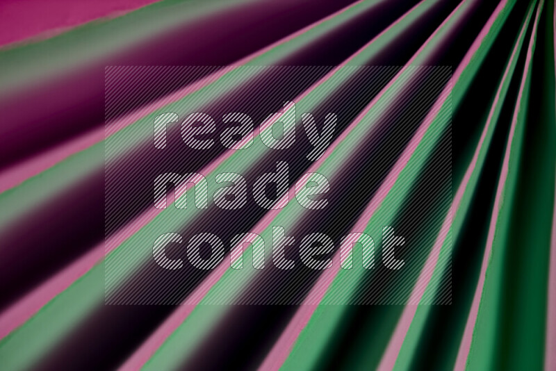 An image presenting an abstract paper pattern of lines in green and pink tones