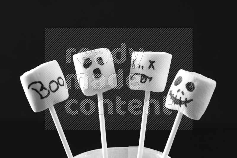 Halloween shapes on marshmallows on black background