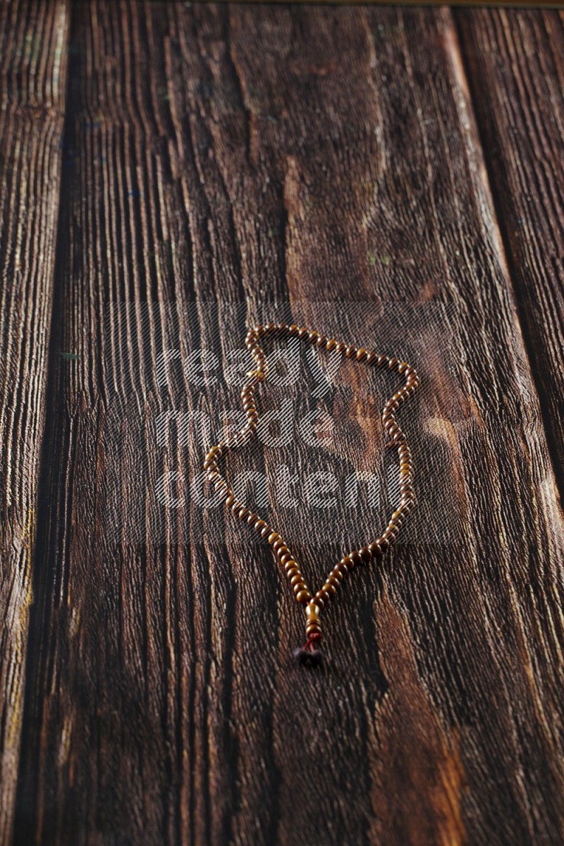 Prayer beads on wooden background