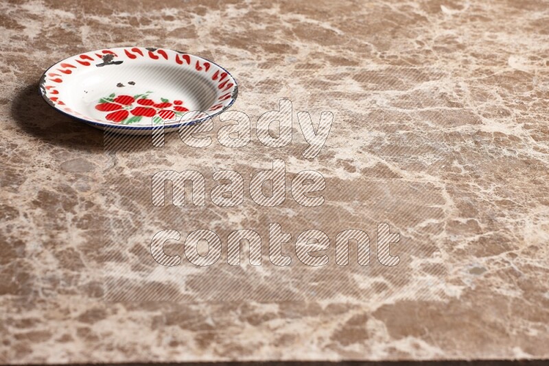 A vintage metal plate on beige marble background