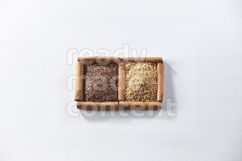 2 squares of cinnamon sticks full of flaxseeds and sesame on white flooring