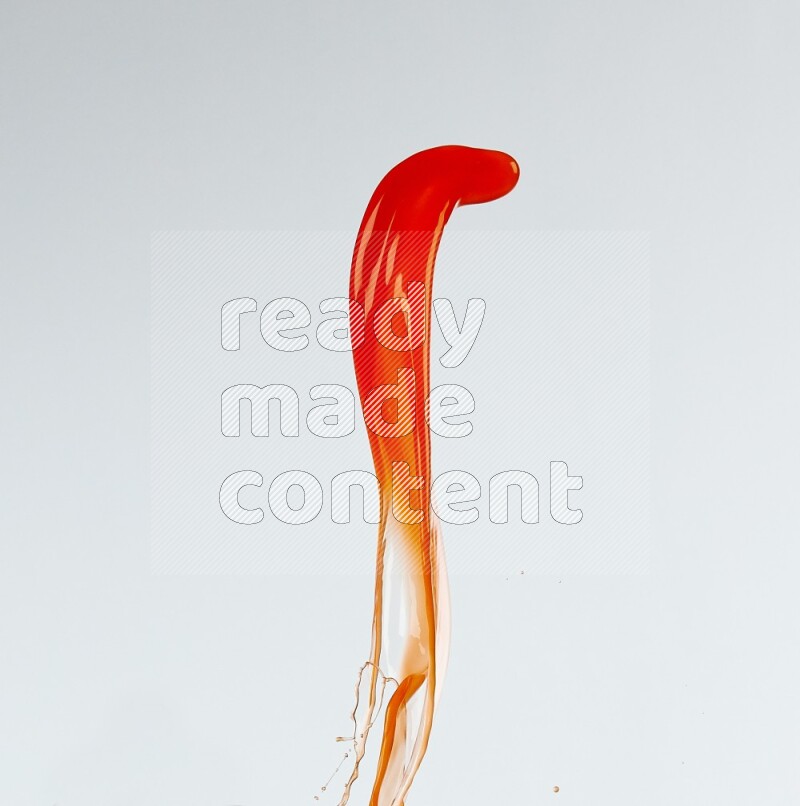 Orange liquid splash and drops on white background
