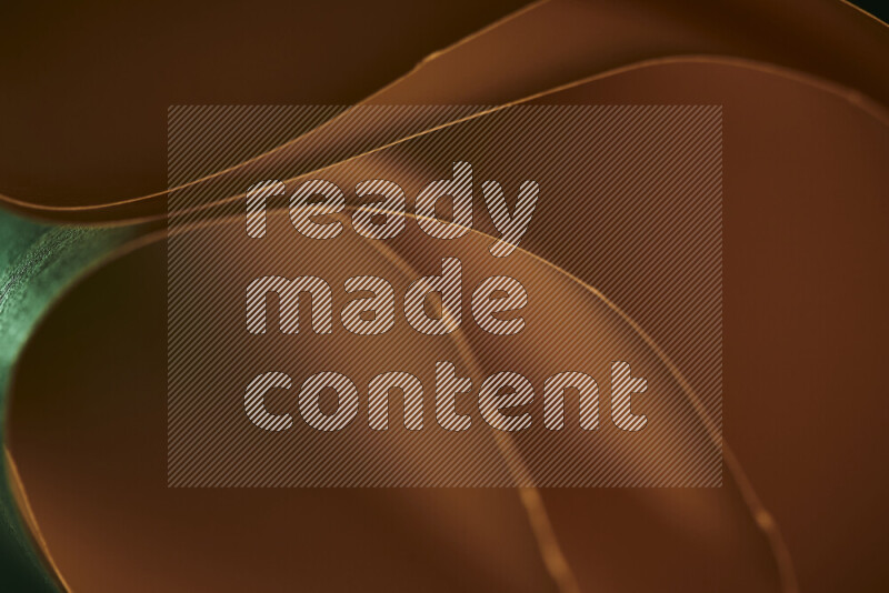 فن تجريدي يعرض منحنيات وتدرجات اللون الأخضر والبرتقالي مكونه بضوء ملون