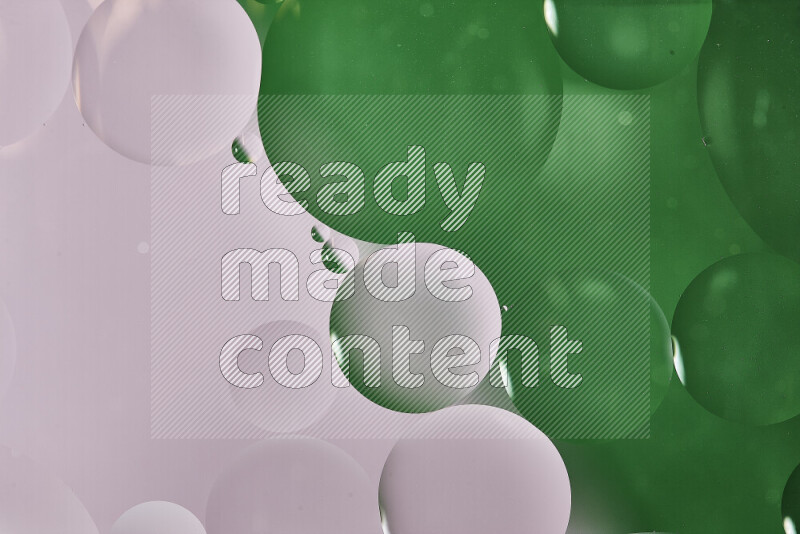 Close-ups of abstract oil bubbles on water surface in shades of white and green