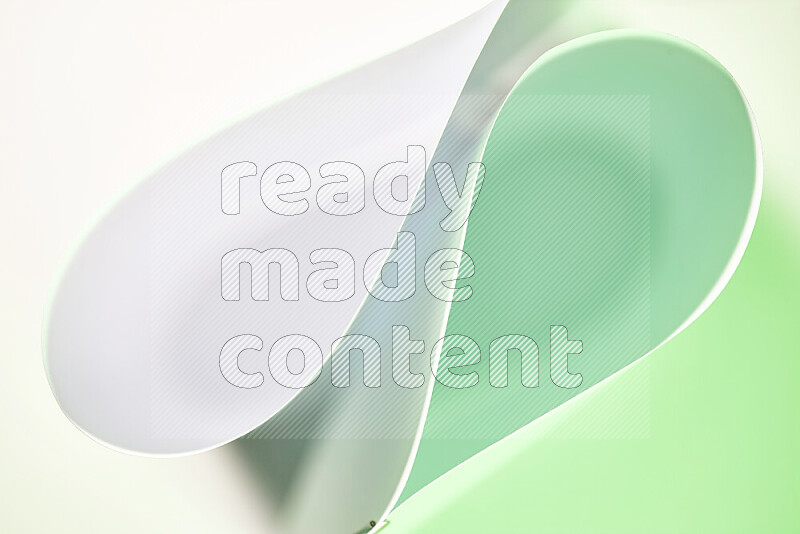 An abstract art of paper folded into smooth curves in white and green gradients