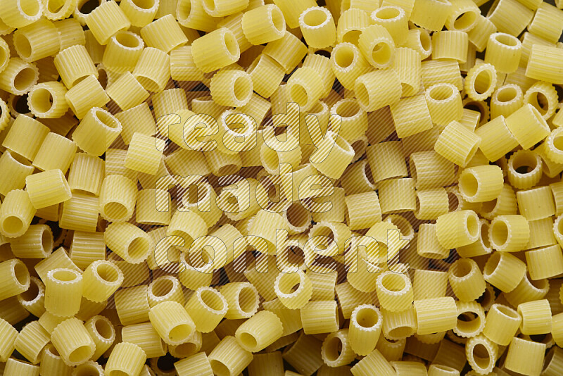 Big rings pasta on grey background