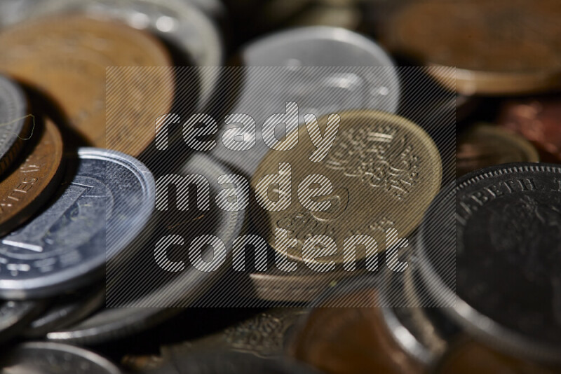 A close-ups of random old coins on black background