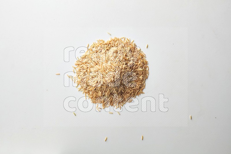Top-view shot of long grain brown rice on white background