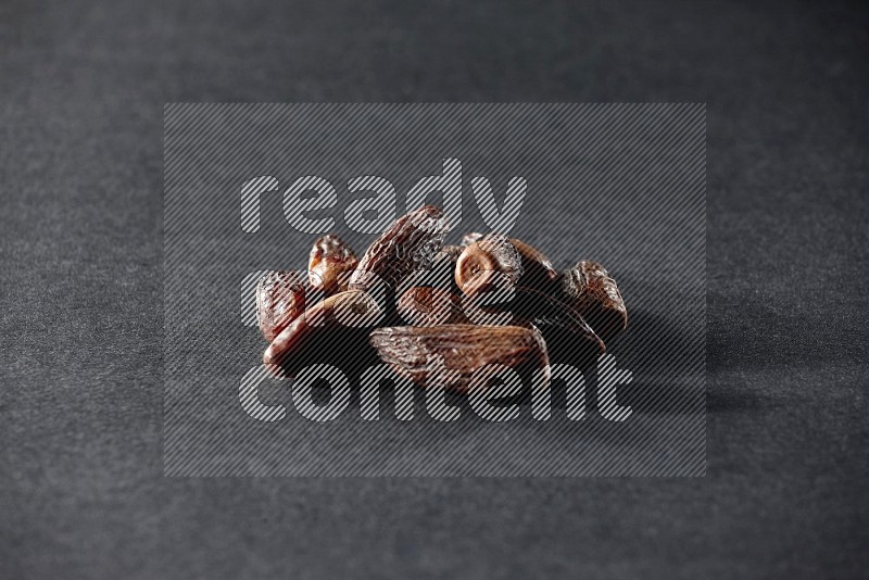 Dried dates on a black background in different angles