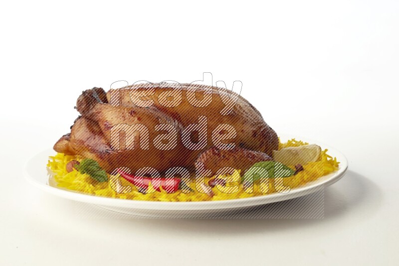 yellow  basmati Rice with  whole roasted chicken on a white rounded plate direct on white background