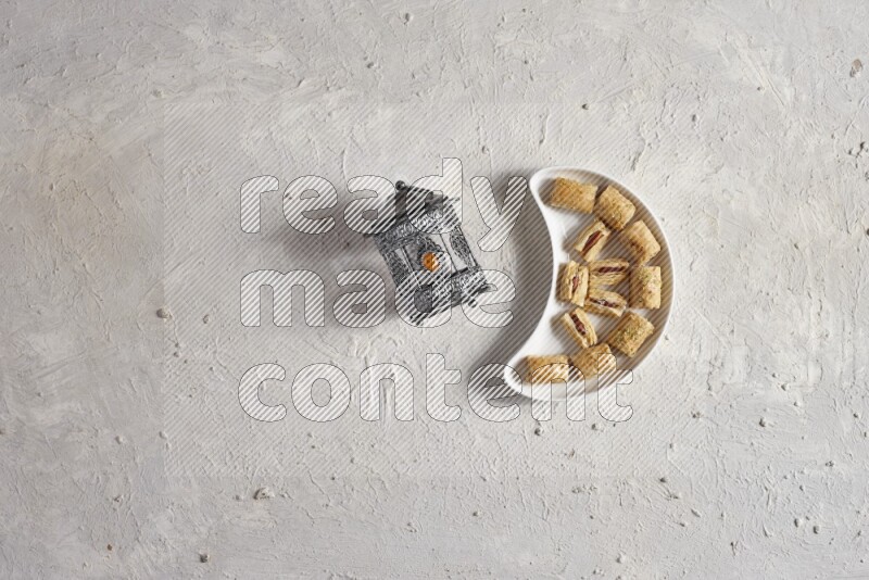 Oriental sweets in a pottery plate with lantern in a light setup