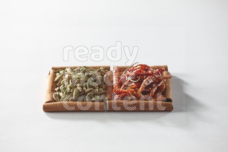 2 squares of cinnamon sticks full of cardamom and dried red chilis on white flooring