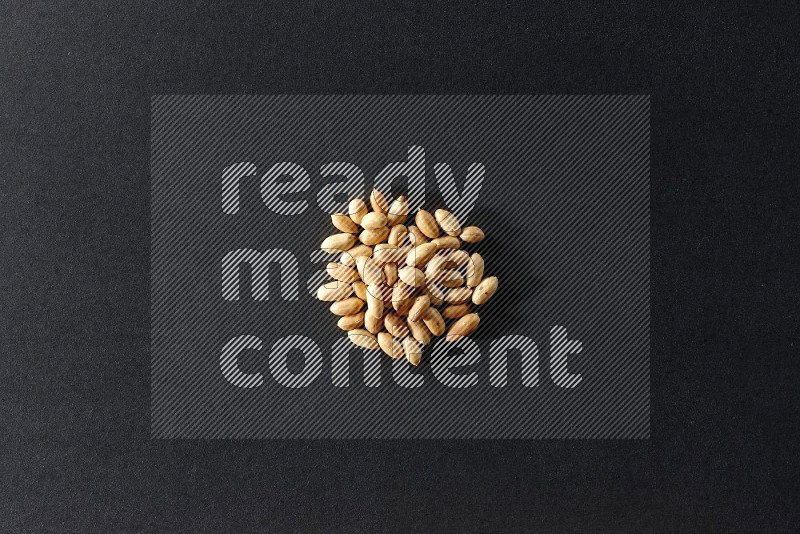 A bunch of peeled peanuts on a black background in different angles