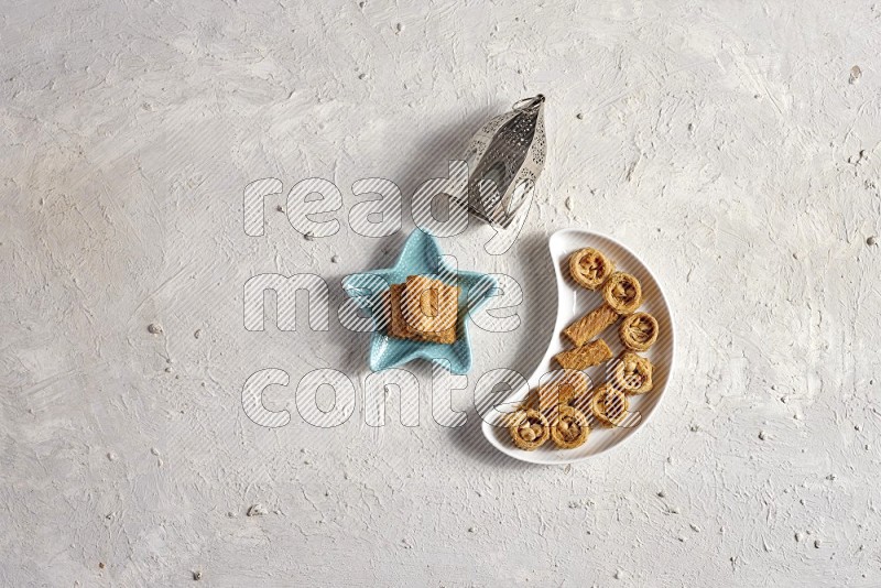 Oriental sweets in a pottery plate with lantern in a light setup