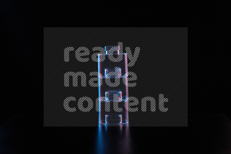 Glassware with rim light in red and blue against black background