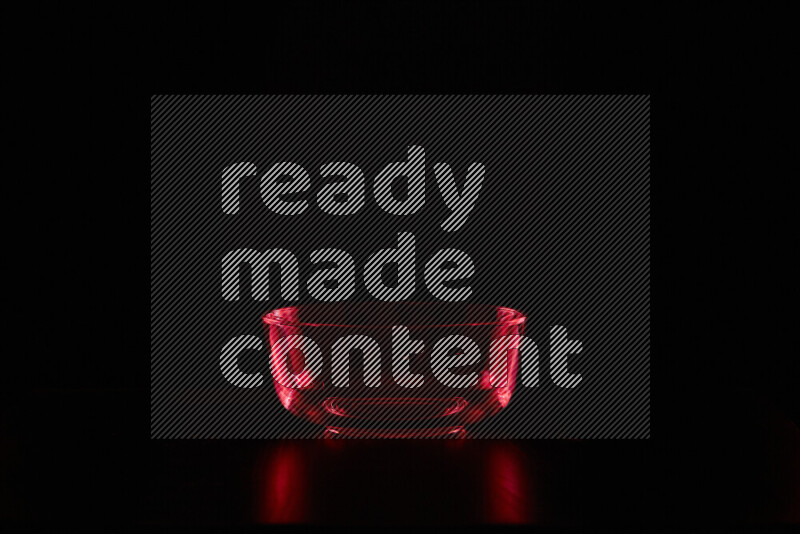 Glassware with rim light in red against black background