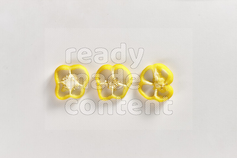 Yellow bell pepper slices on white background