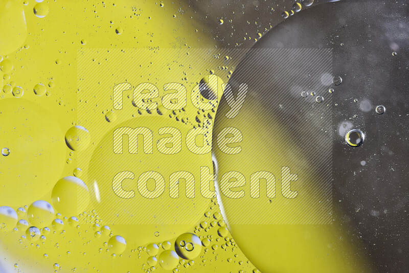 Close-ups of abstract oil bubbles on water surface in shades of yellow and brown