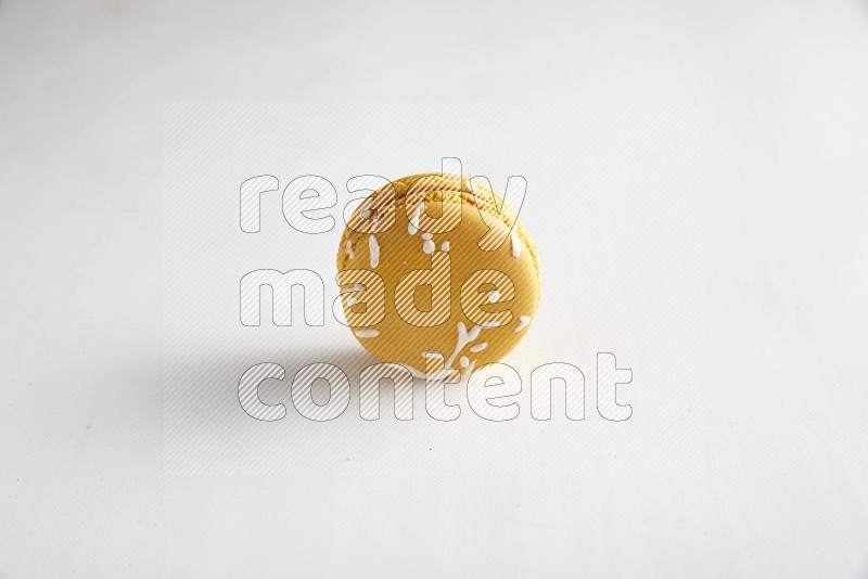 45º Shot of Yellow Piña Colada macaron on white background