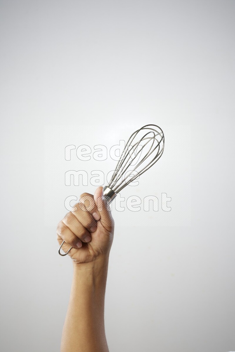 Male Hand Holding Whisk on white background