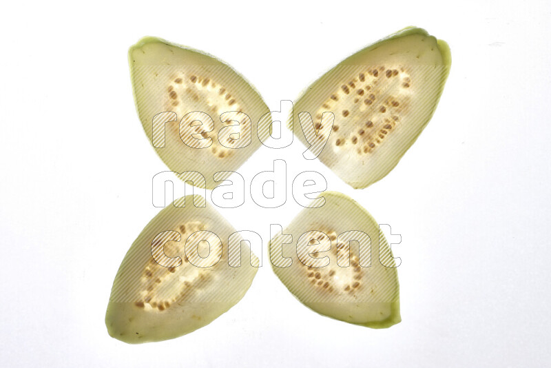 Guava slices on illuminated white background