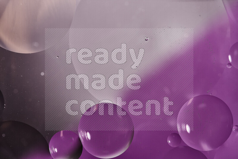 Close-ups of abstract oil bubbles on water surface in shades of white and purple