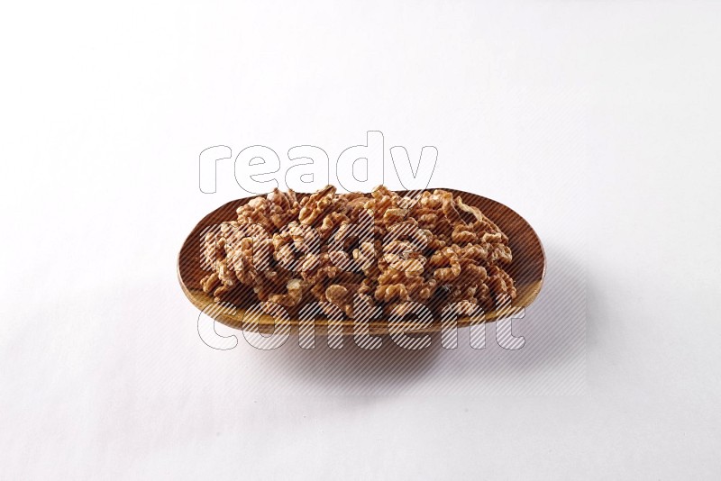 Walnuts in a wooden plate on white background