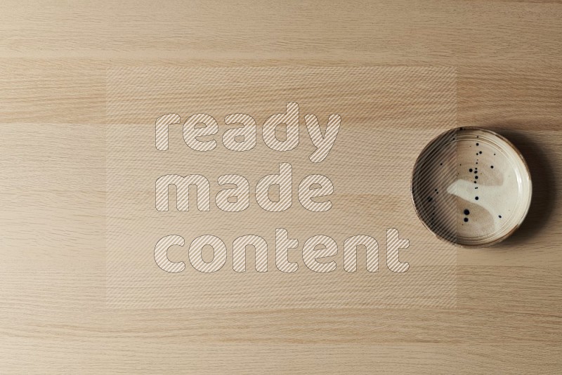 Top View Shot Of A Multicolored Pottery Plate on Oak Wooden Flooring