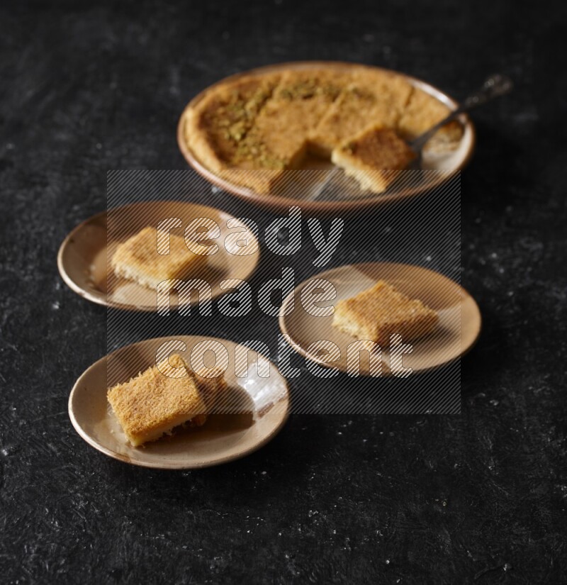 Konafa in different plates in a dark setup