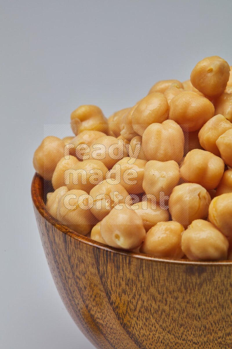 Close up of a boiled chickpeas in a container on white background