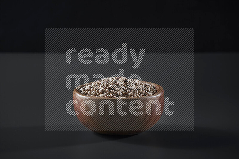 Black-eyed peas in a wooden bowl on grey background