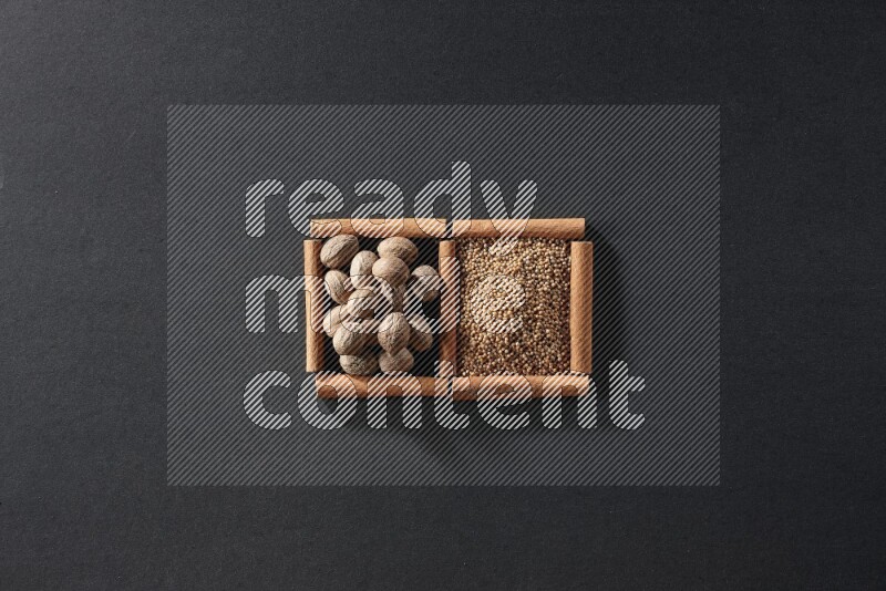 2 squares of cinnamon sticks full of mustard seeds and nutmeg on black flooring