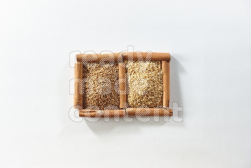 2 squares of cinnamon sticks full of mustard seeds and sesame on white flooring