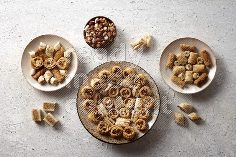 Oriental sweets in pottery plates with nuts in a light setup