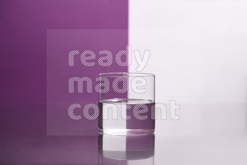 The image features a clear glassware filled with water, set against white and purple background