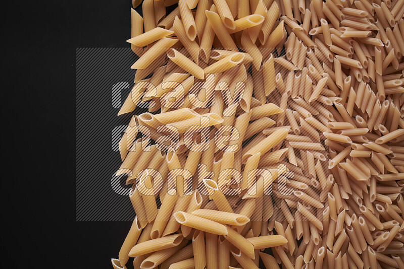 Different pasta types on black background