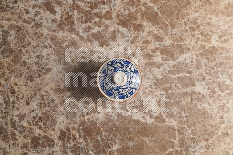 A multicolored pottery pot on beige marble background