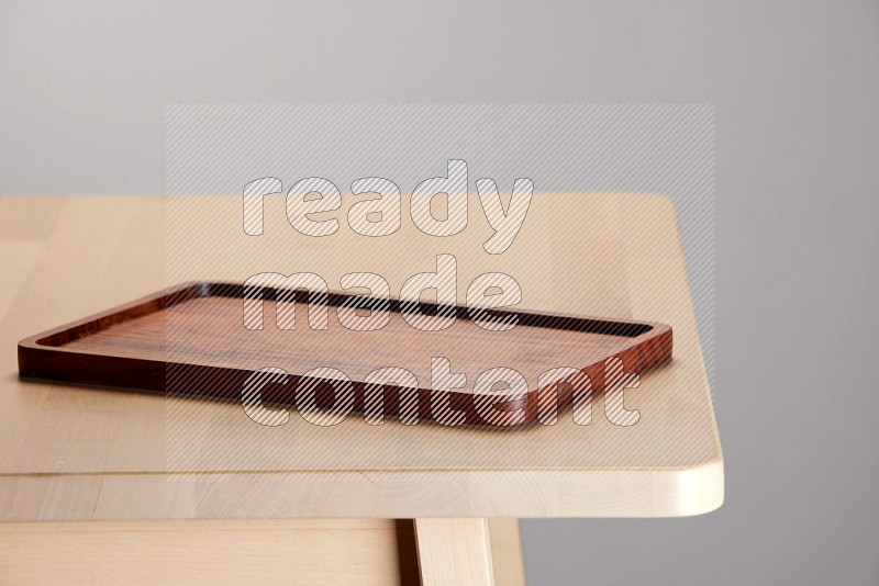 wooden trays and cutting boards on the edge of wooden table