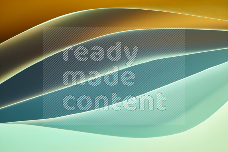 هذه الصورة تعرض تكوين فن الورق التجريدي مع منحنيات ورقية بتدرجات اللون الأخضر والبرتقالي المكونه بواسطة الضوء الملون