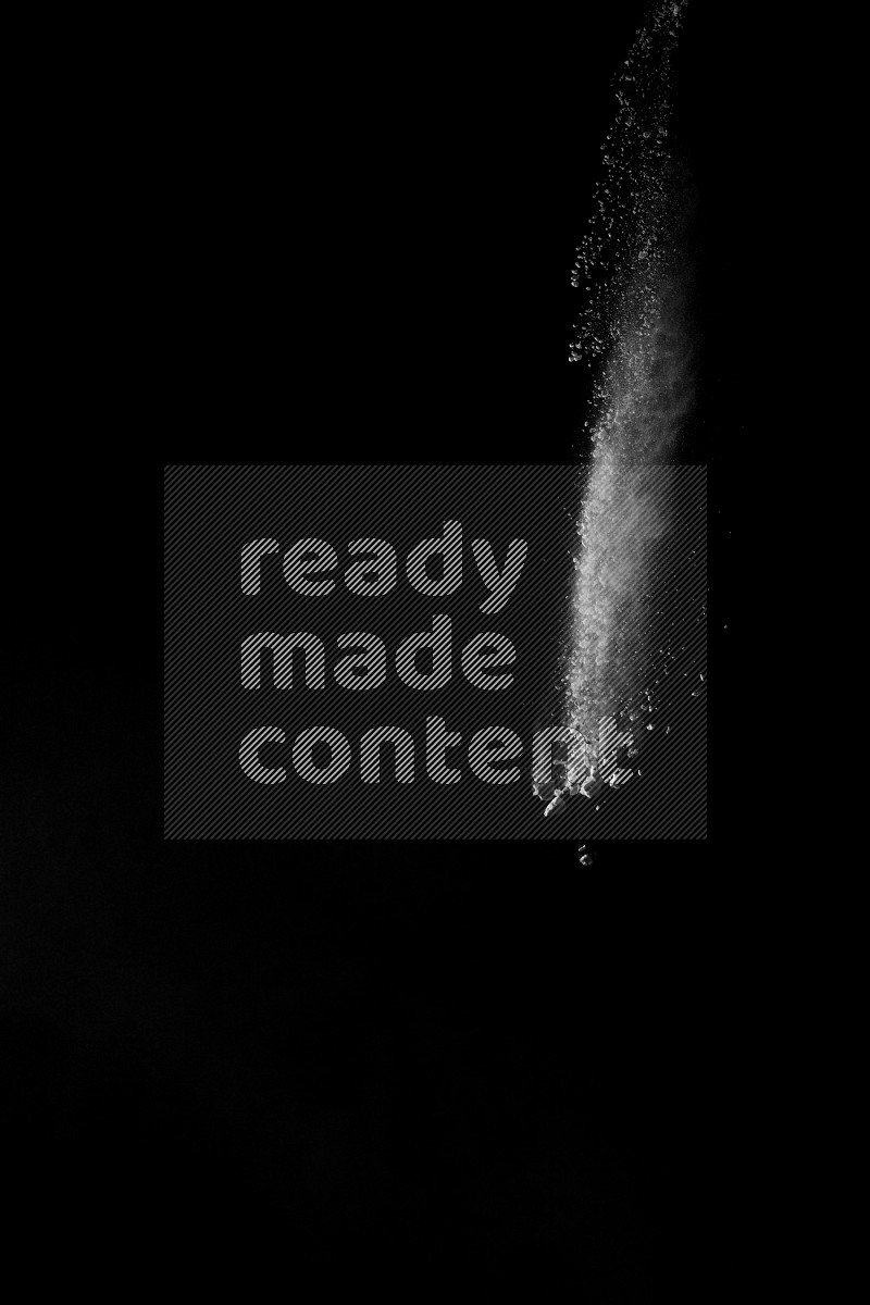 A side view of white powder explosion on black background