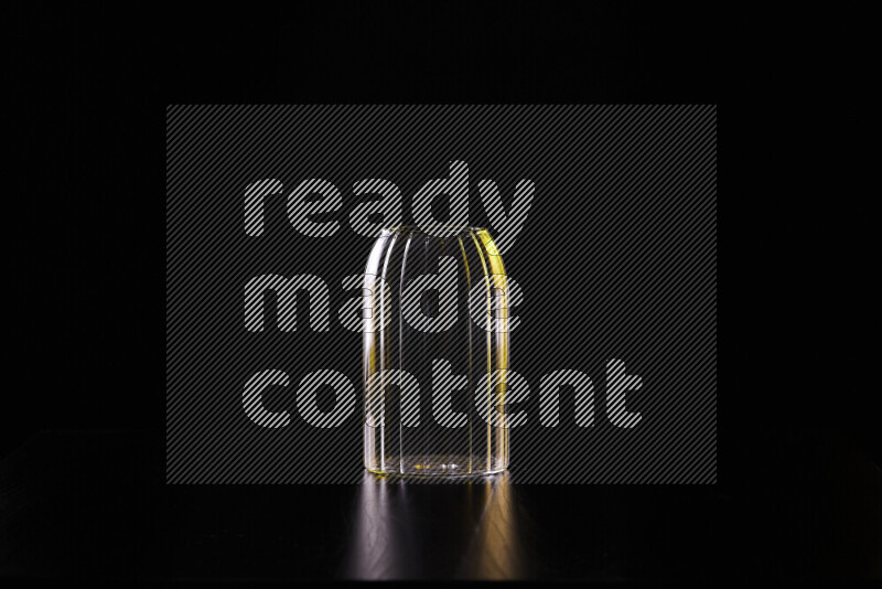 Glassware with rim light in yellow and white against black background