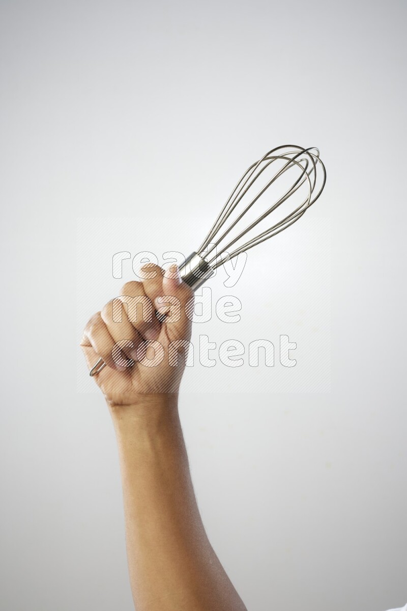 Male Hand Holding Whisk on white background