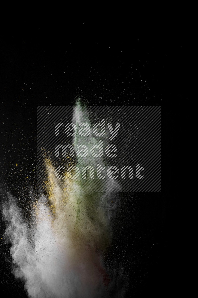 A side view of multicolored powder explosion on black background